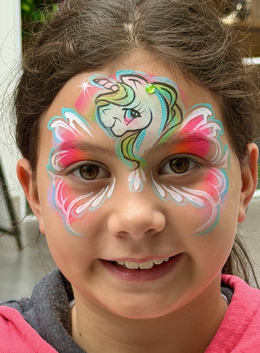 Pink unicorn with butterfly wings around eyes