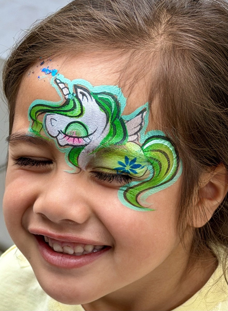 Green unicorn design on forehead
