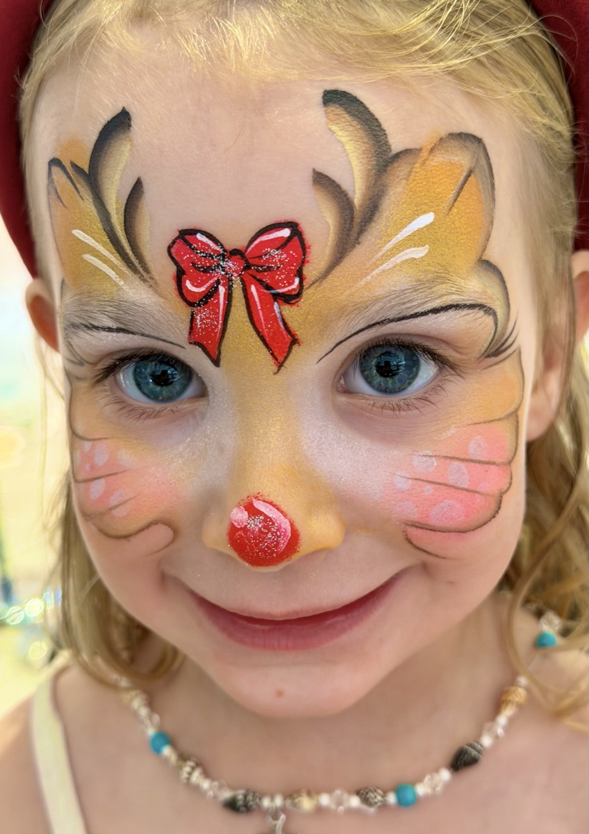 Full-face reindeer with red bow