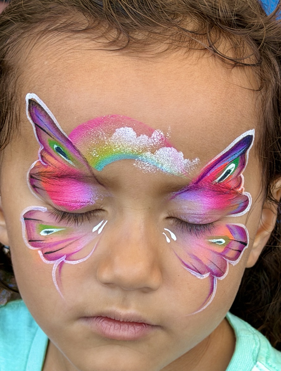 Pink butterfly with rainbow arc, eyes closed