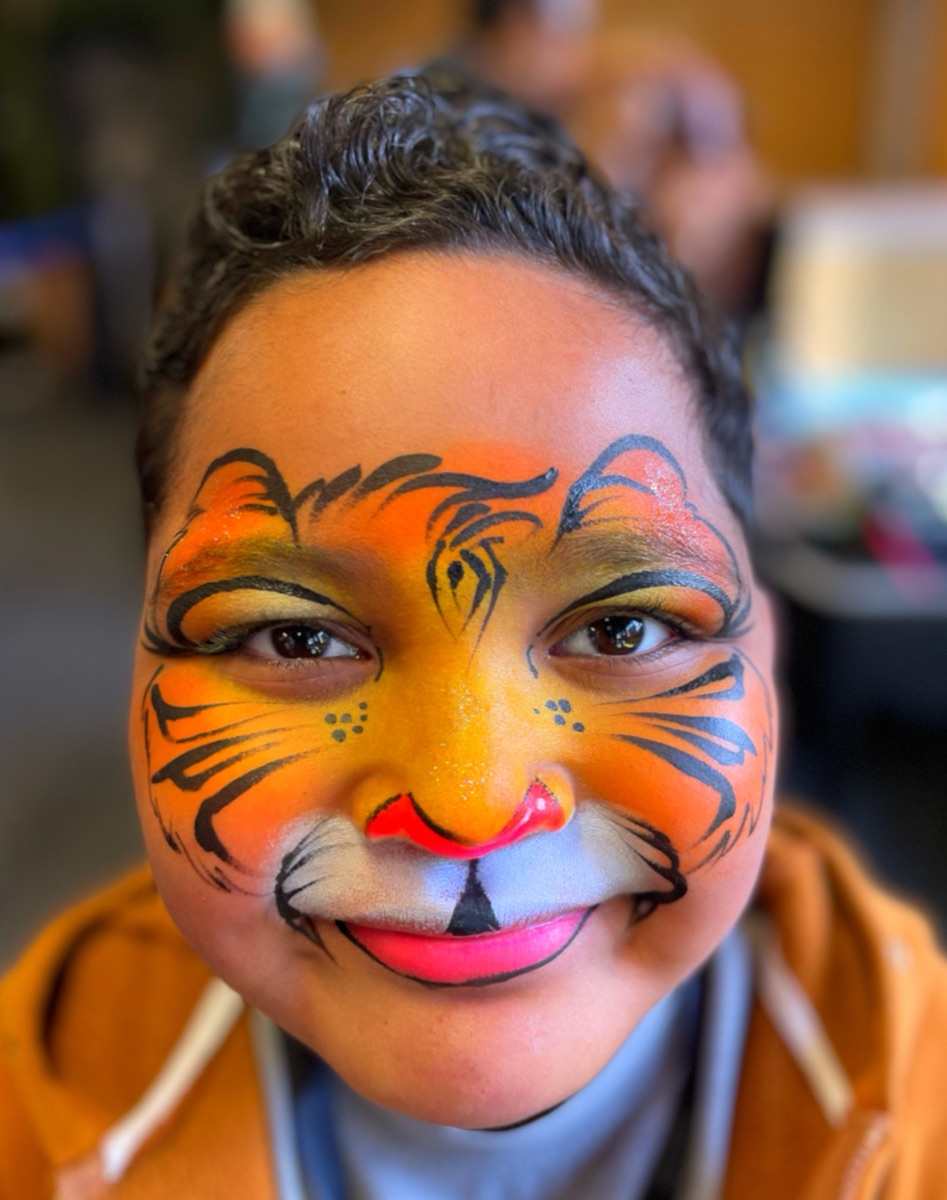 Tiger face paint design on a child